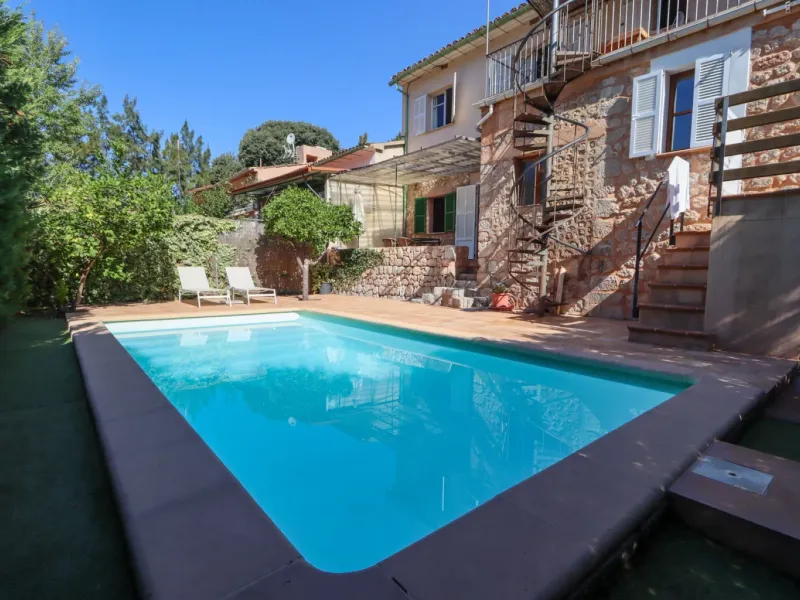 A two-apartment house on a quiet street, featuring a private pool